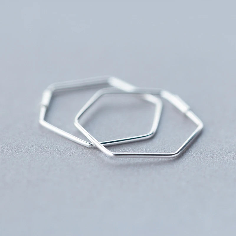 Elegant geometric silver hoop earrings displayed on white card as ear rings