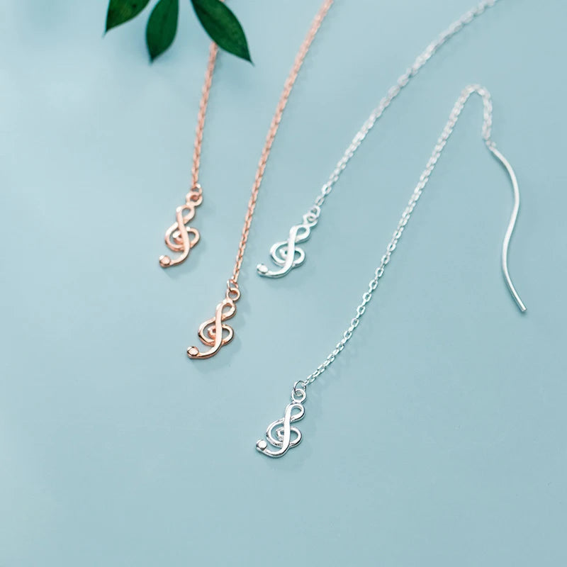 Long chain silhouette on musical note earrings with rose gold touch