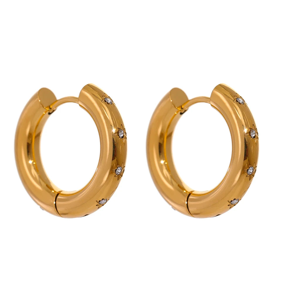 Cubic zirconia starburst earrings in a gold plated huggie hoop design