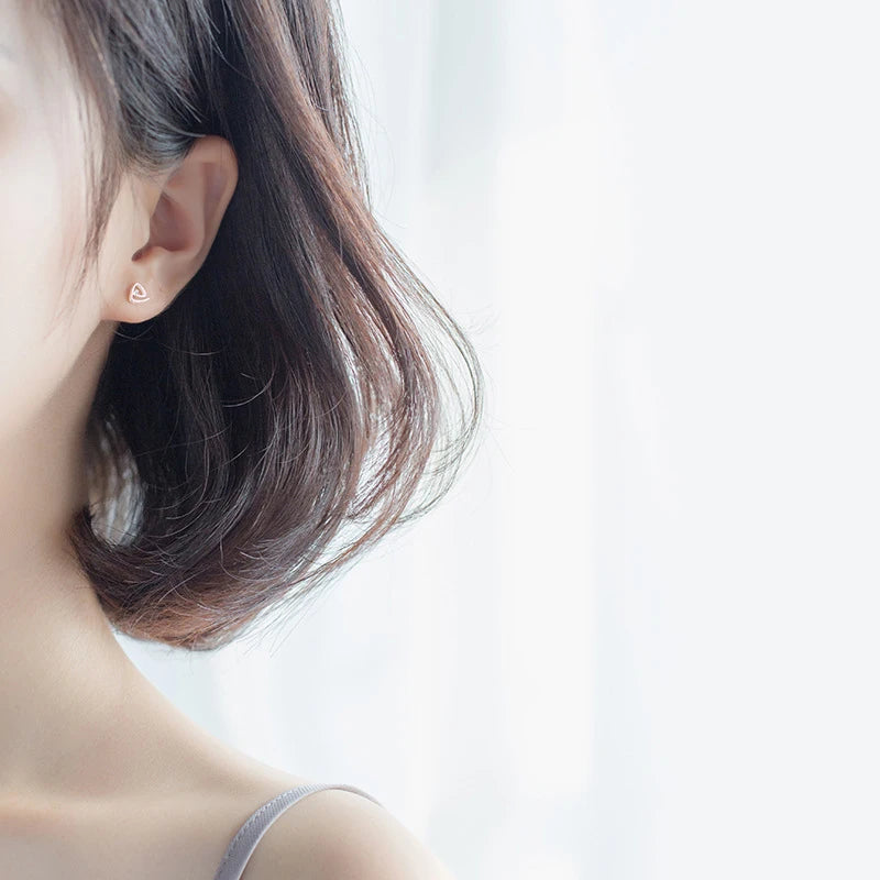 Sterling silver earrings shown as stud earrings with smooth silver color finish