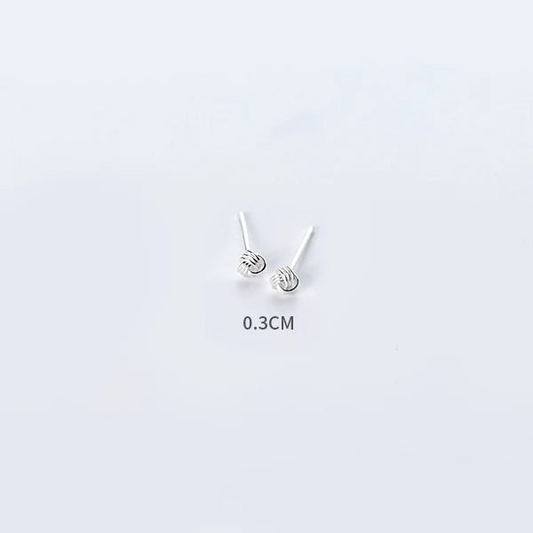 Sterling silver earrings shown as minimal stud earrings for women