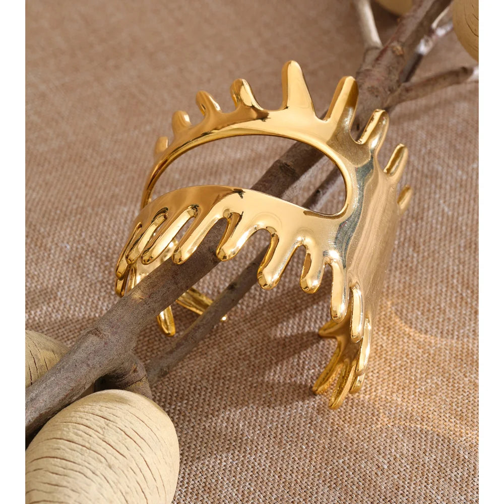 Close up of bracelet gold bracelet with wide sculptural shape