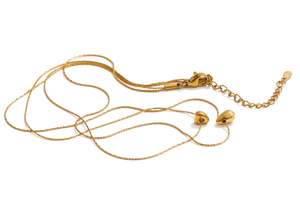 Editorial angle of necklace and necklace layered look with gold plated finish