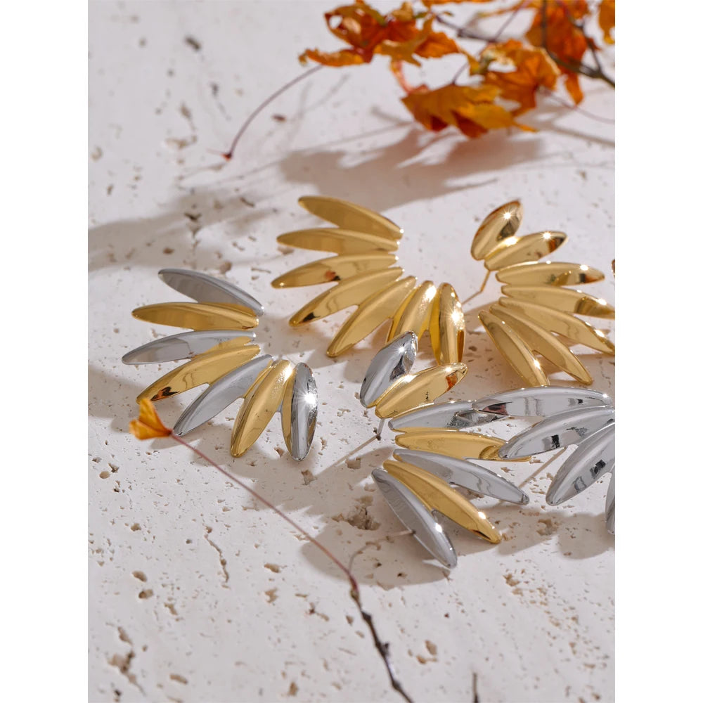 Close-up of gold earrings in stainless steel jewelry design