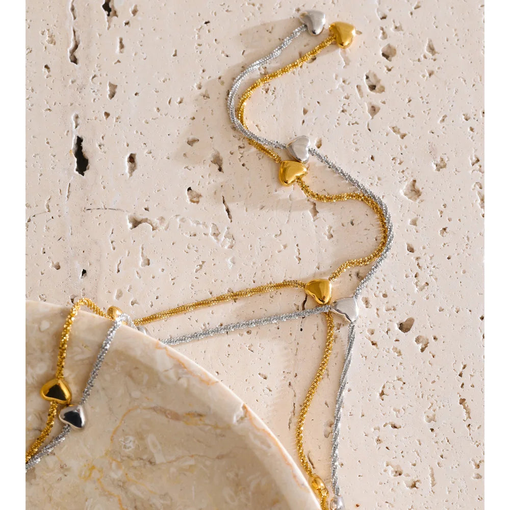 Close up of heart necklace gold plated hanging down the chest