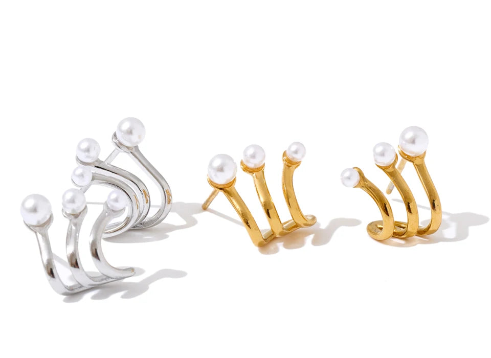 Women with earrings wearing geometric pearl gold studs