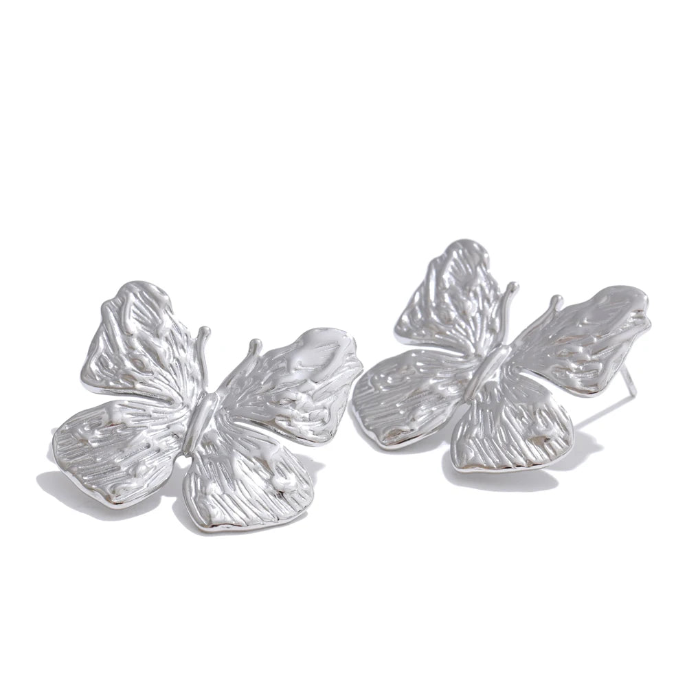 Minimal shot of earring earrings with butterfly motif and gold a earrings tone