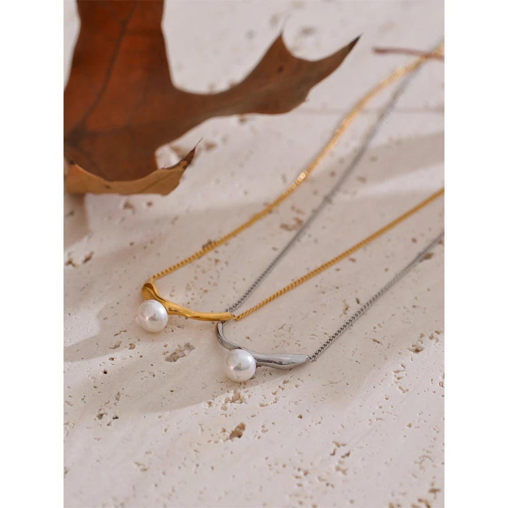 Close-up of pearl on necklace with golden chain design