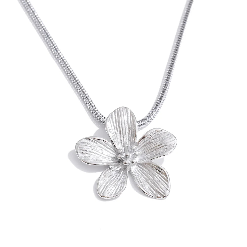 Radiant gold plated floral pendant hanging on chain