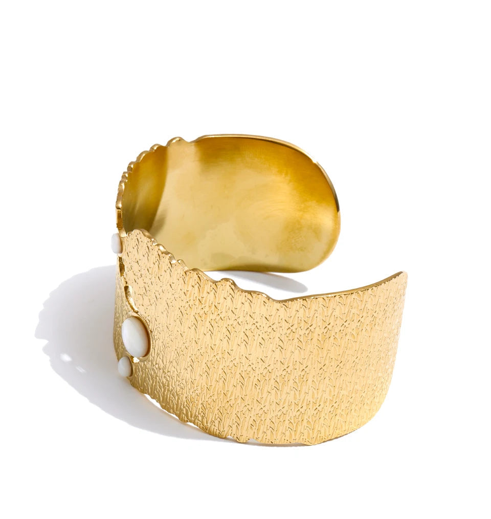 Bangle and bangle stack featuring a wide shell gold plated cuff