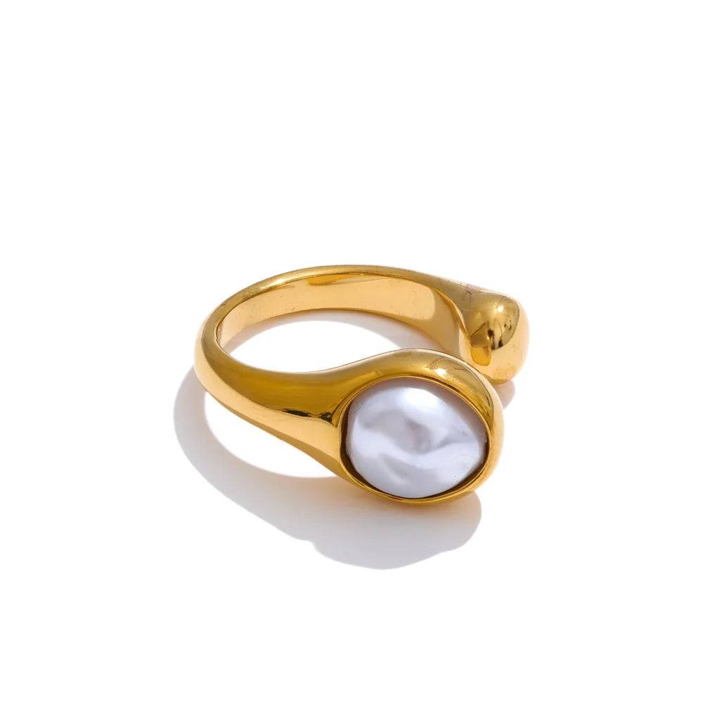 Fashion shot of a pearl ring layered with bands for ring with size elegance