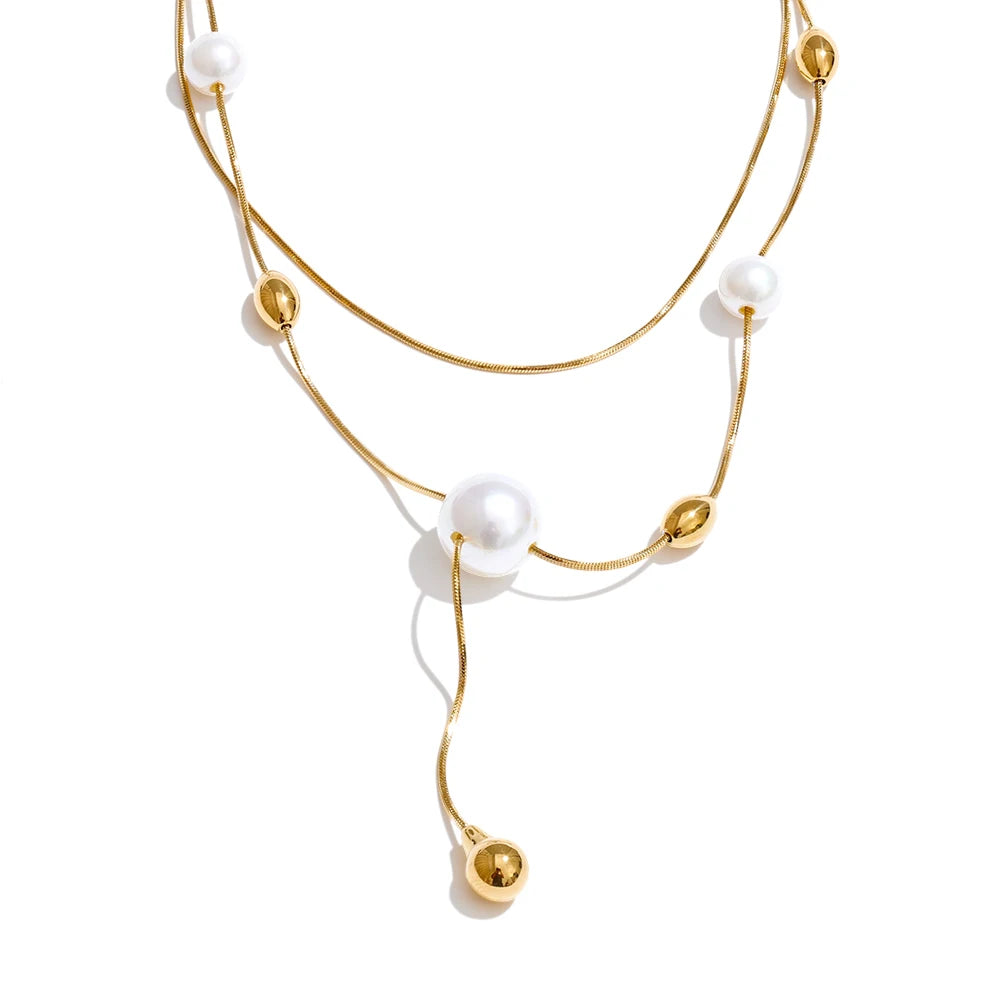 Pearl in necklace detail paired with gold plated metal
