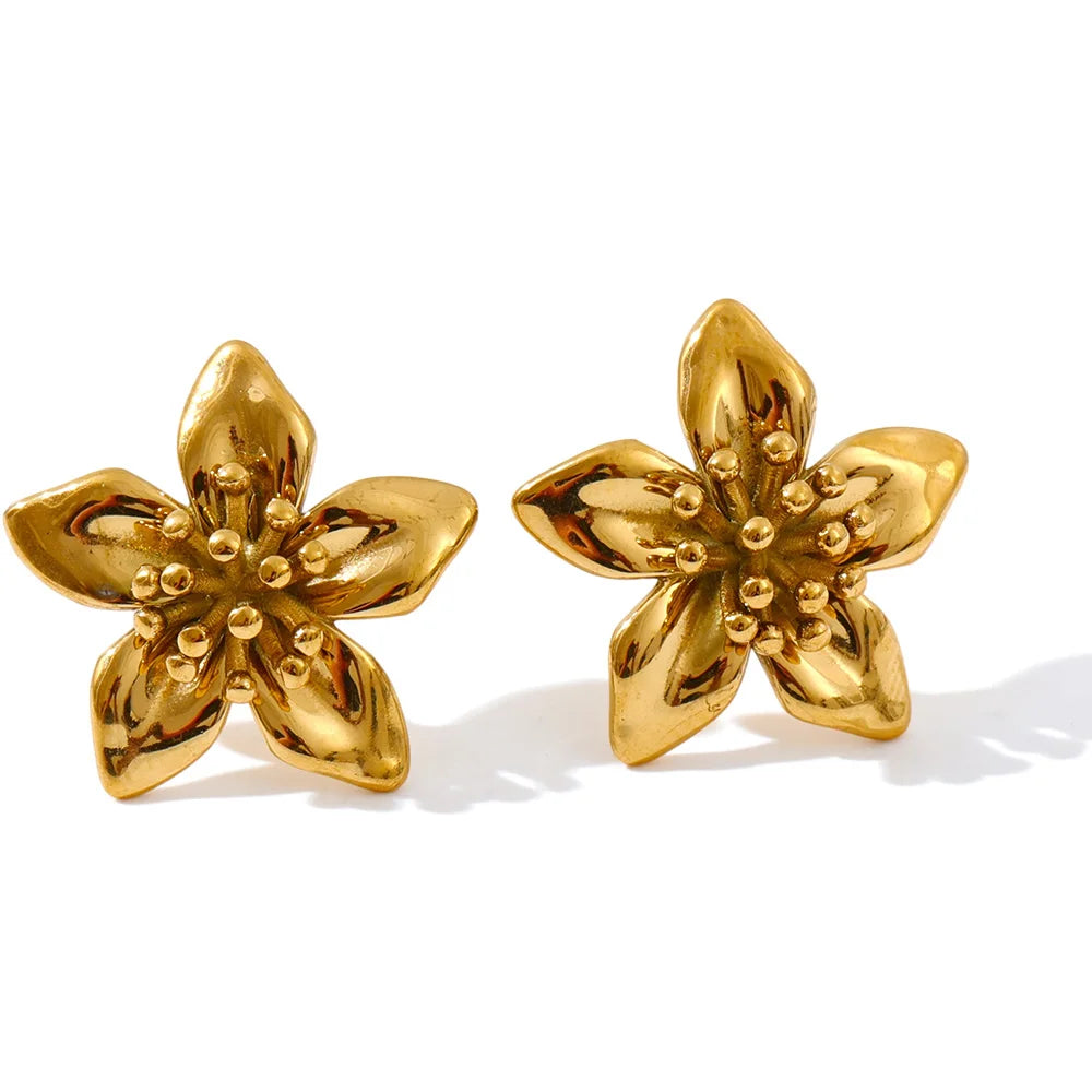 Elegant flat lay pairing ring with gold and golden jewelry earrings