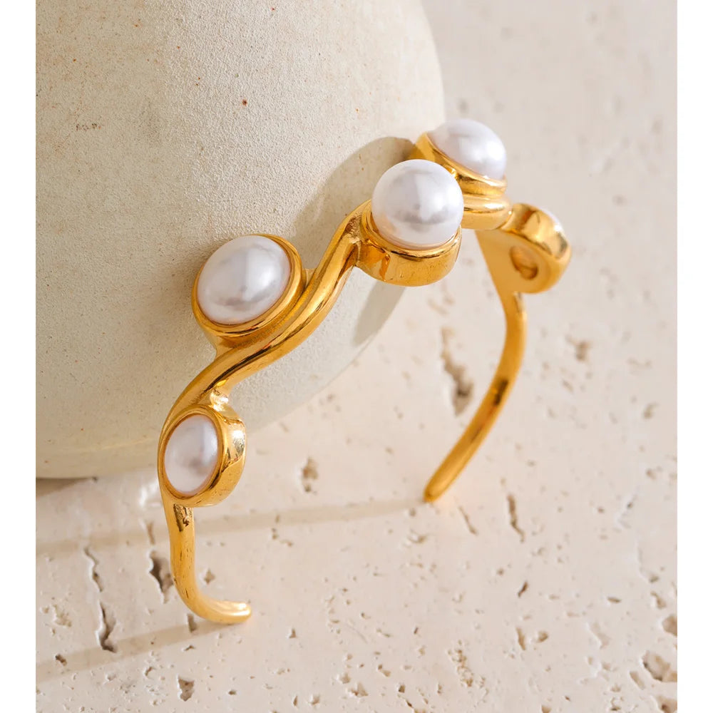 Elegant bangle bracelet featuring simulated pearls