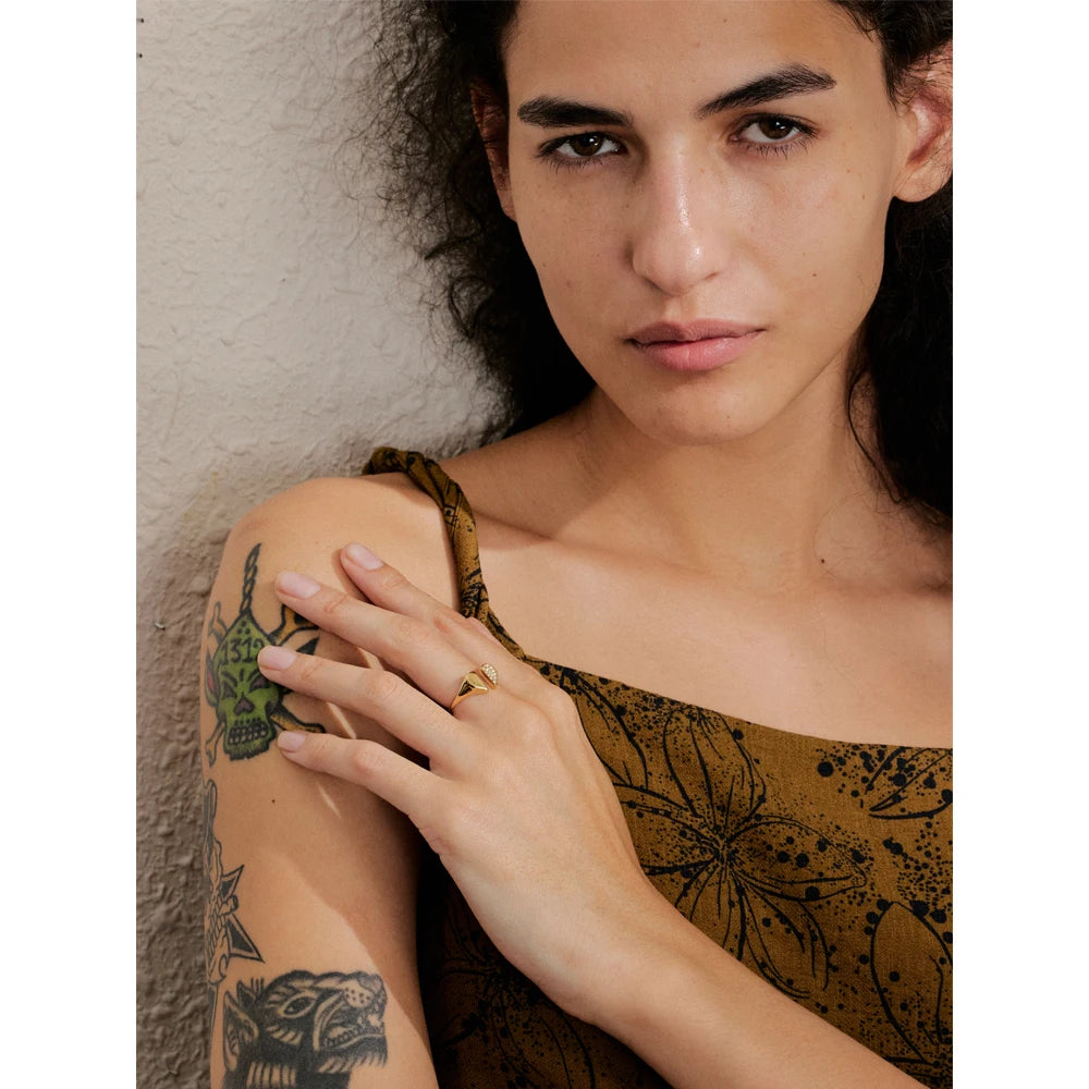 Close-up of cubic zirconia heart ring on finger in gold plated finish