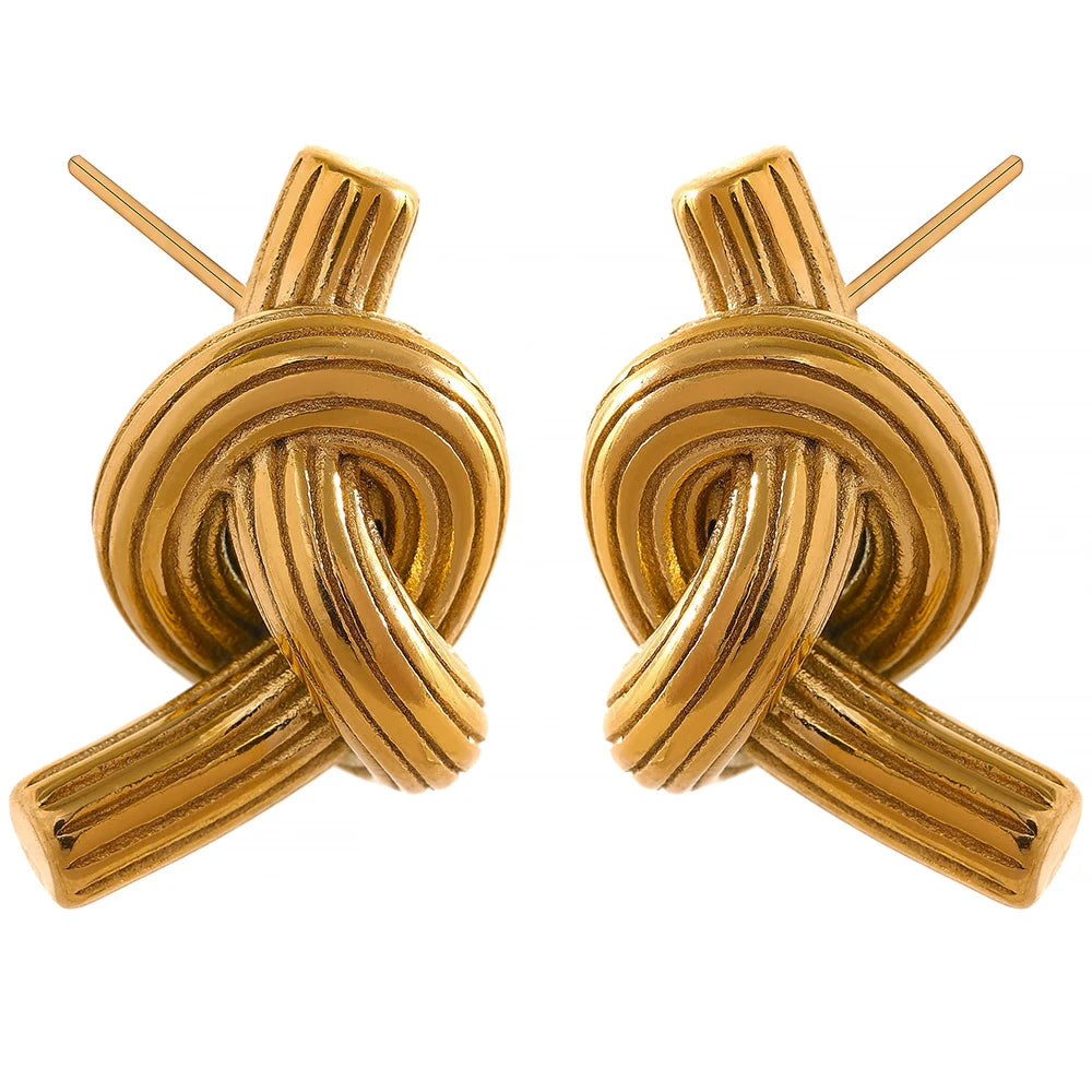 Stainless steel stud earrings styled as statement earrings with subtle gold earrings accents