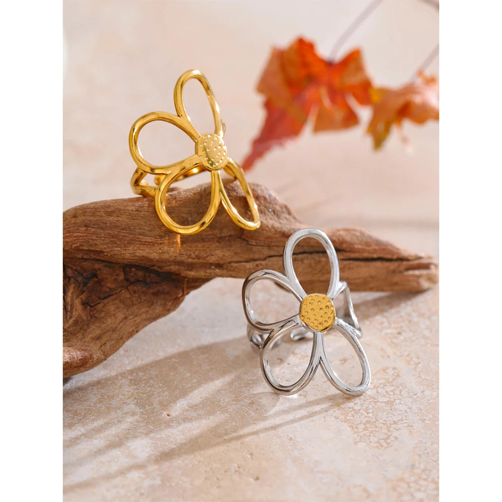 Close-up of flower ring showing adjustable band and polished gold-tone finish