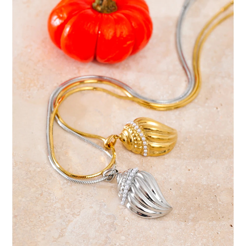 Pendant on a necklace paired with rings with pearls for a coordinated jewelry set