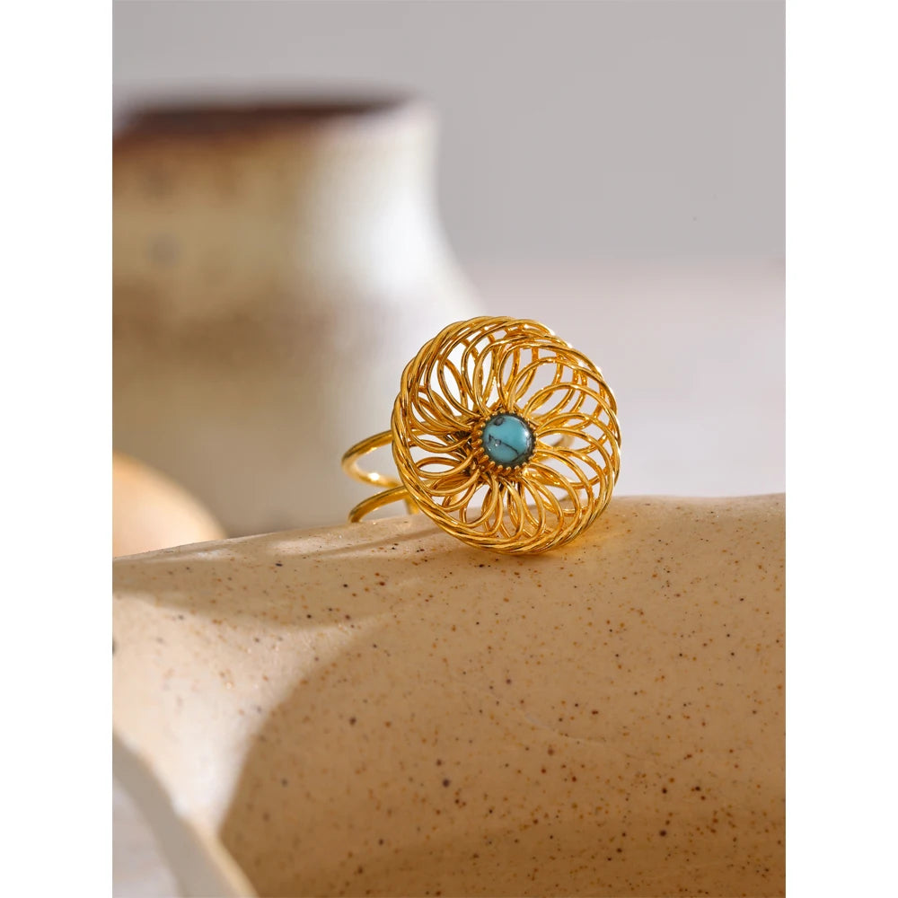 Golden jewelry finish on a textured flower ring crafted from stainless steel