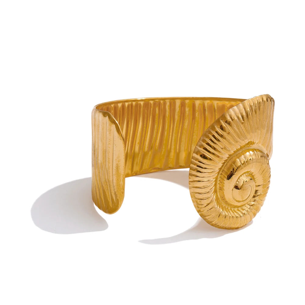 Fashion shot showing a gold bracelet styled as bracelet with gold essentials