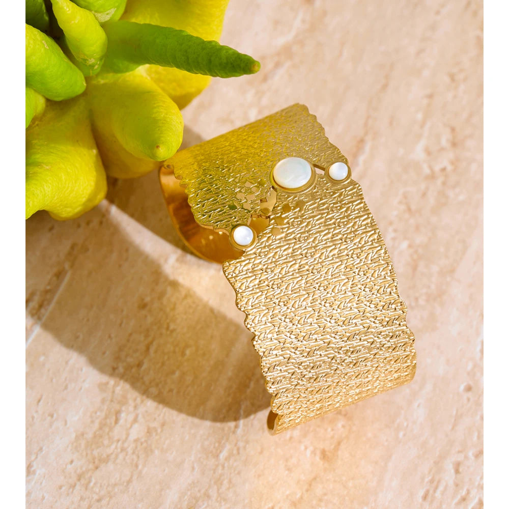 Textured bangle bracelet styled as a sleek gold cuff for daily wear