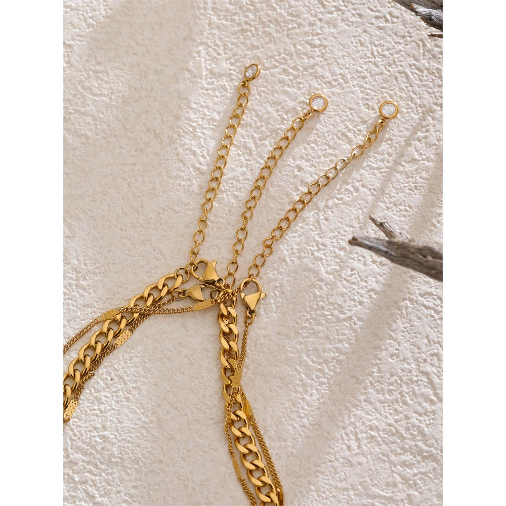 Close-up of round pendant on Cuban chain necklace gold plated finish