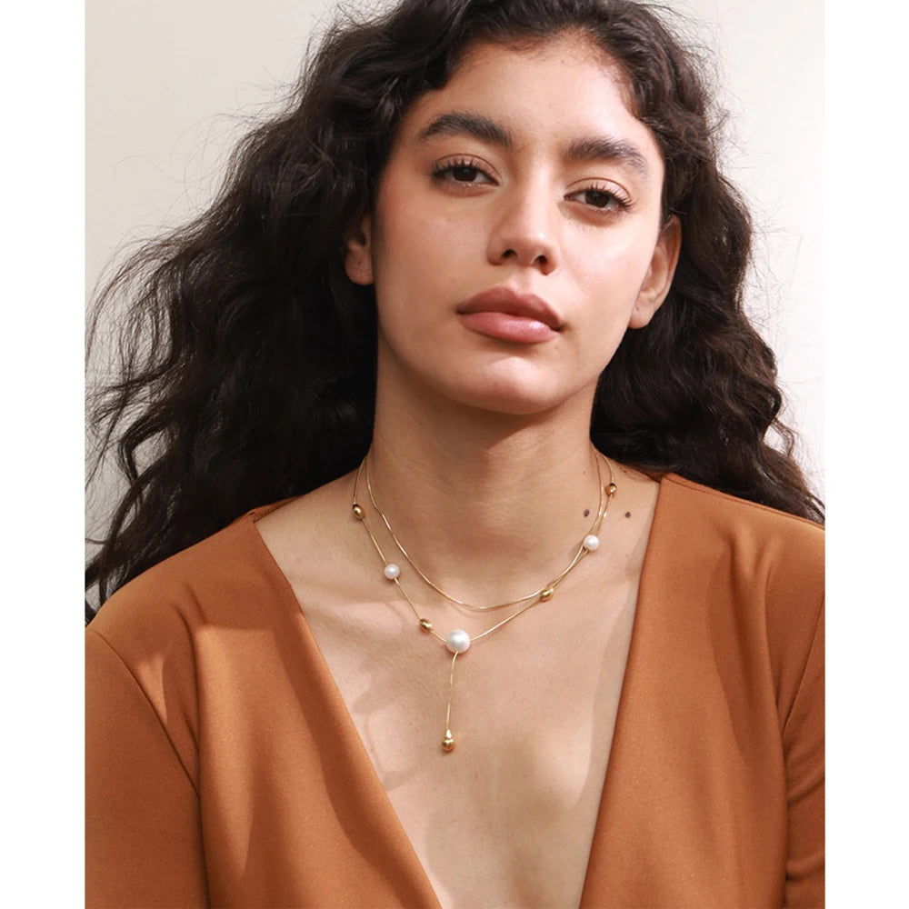 Close up of pearl on a necklace in layered chain design