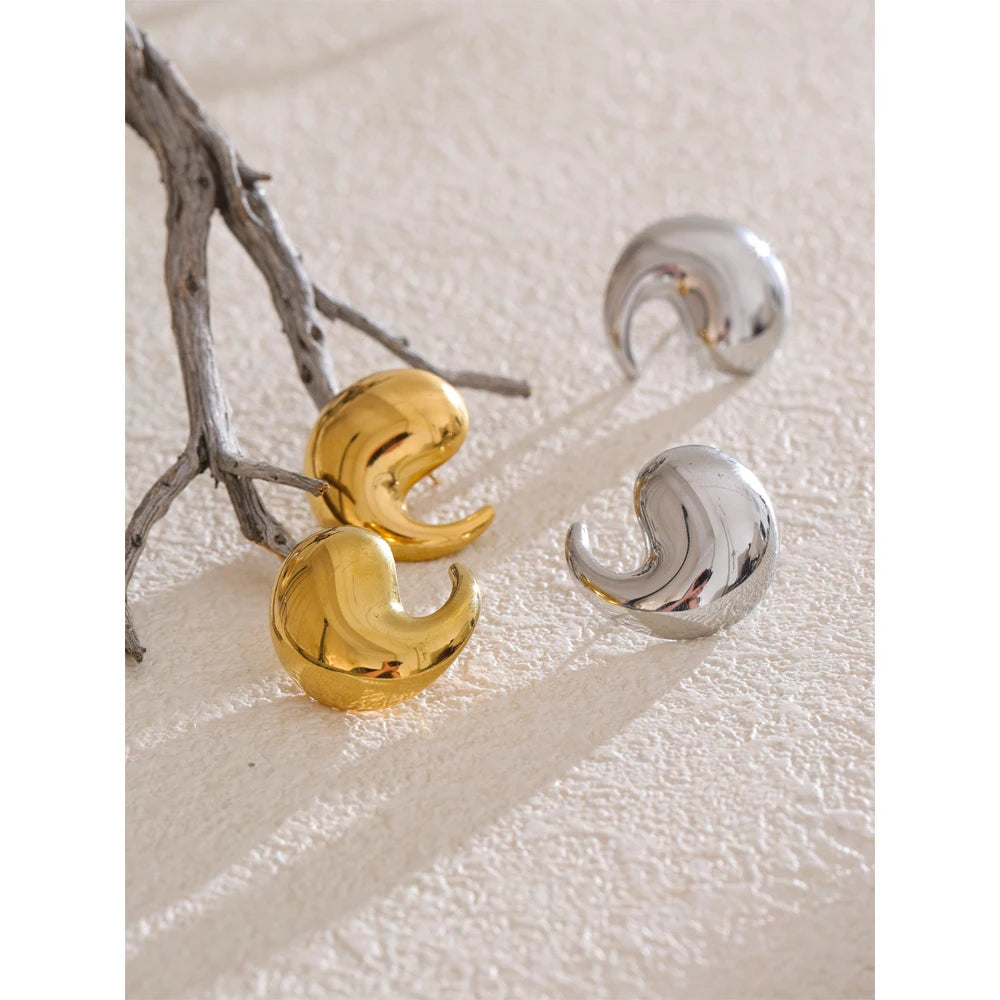 Sculptural comma stud earrings worn by women with jewelry for daily chic