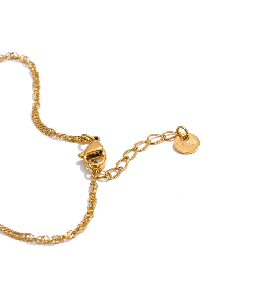 Macro of chain and bracelet junction highlighting gold plated surface and clean lines