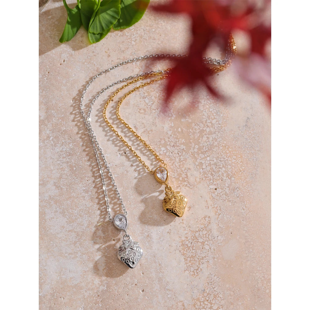 Close view of pendant necklace showing necklace gold necklace shine with strawberry detail