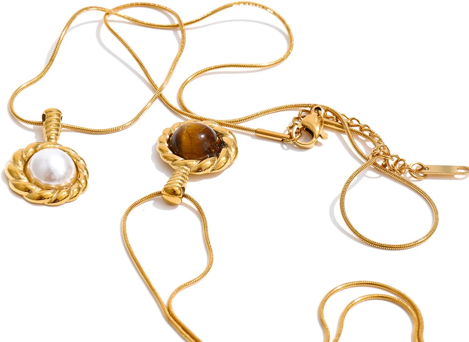 Close up of tiger eye stone pendant with imitation pearl detail