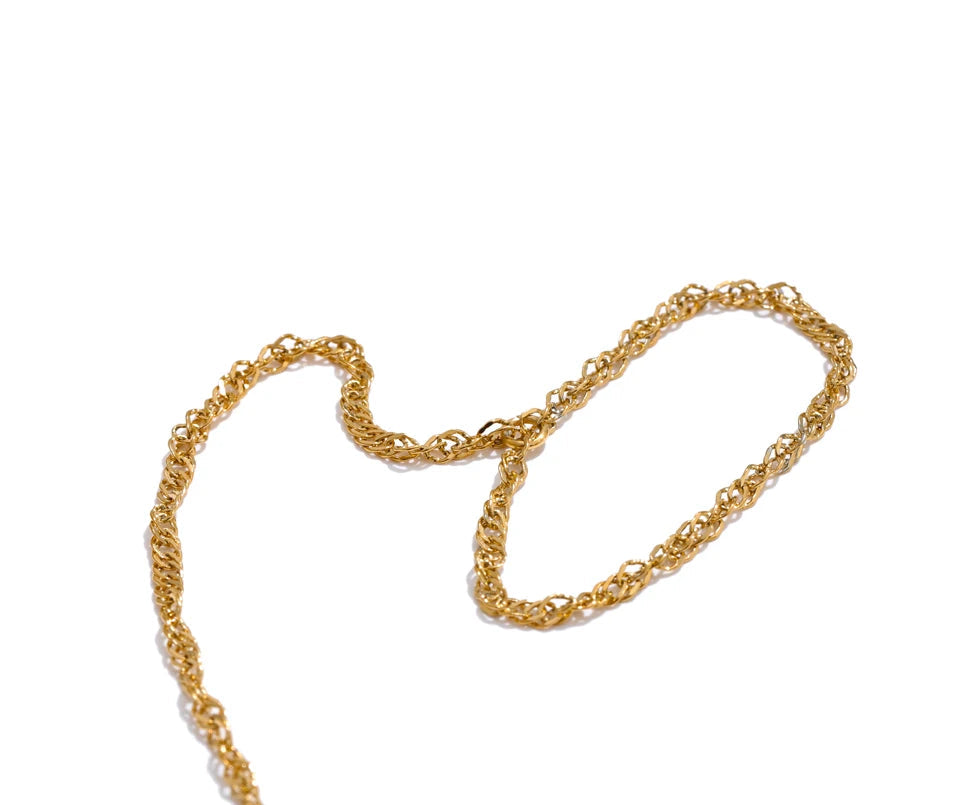 Styled stack with bangle and bangle layered around a gold bracelet bangle and link ring