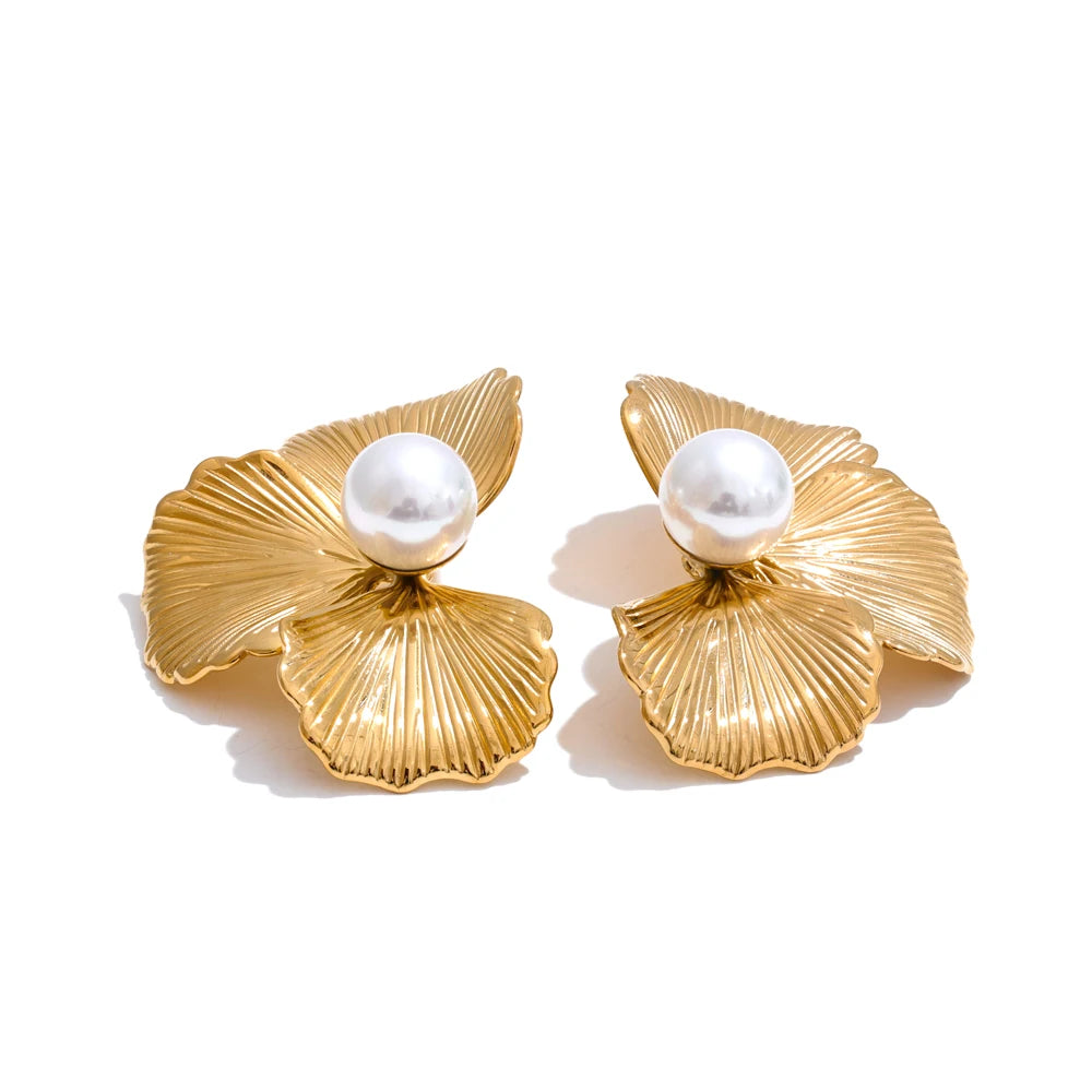 Side profile capturing a gold a earrings contour around a bright pearl