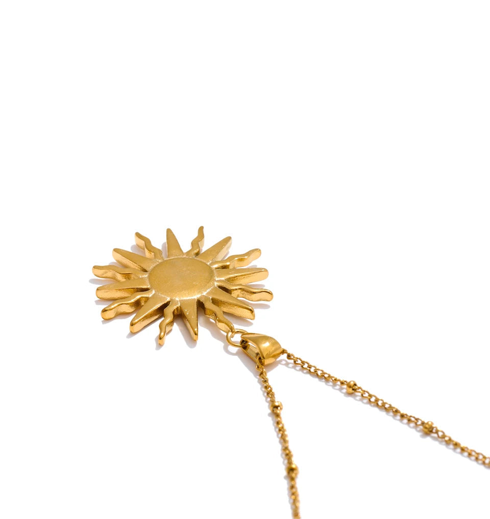 Soft light macro of pendant with necklace showing seashell texture and golden tone