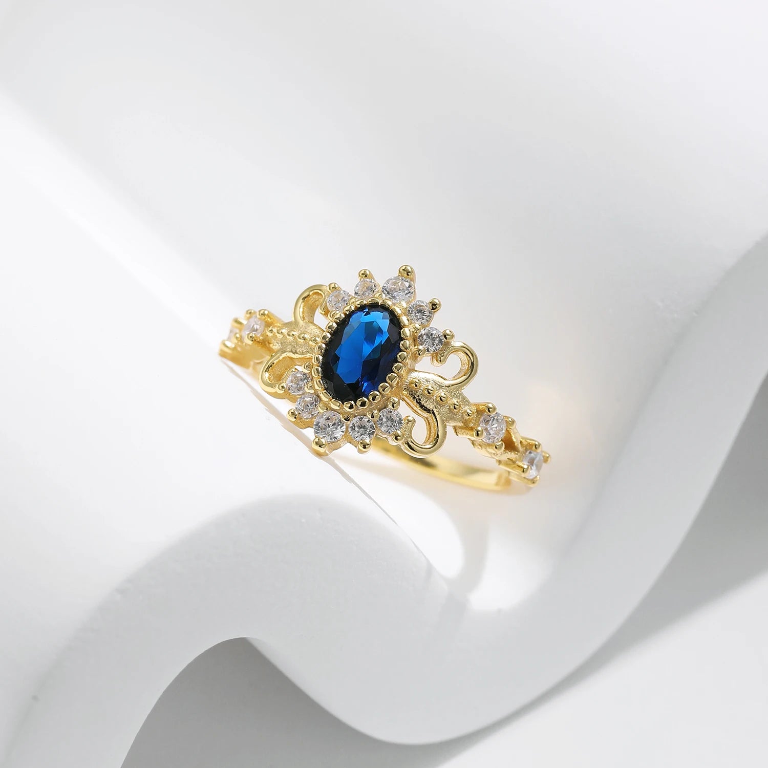 Silver sterling ring featuring vintage crown charm and blue oval