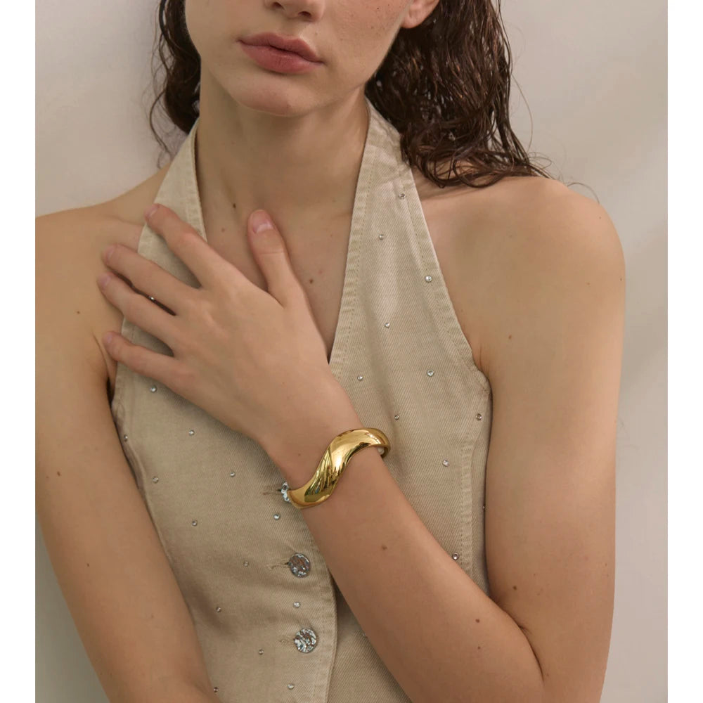 Close up of bracelet with gold surface and sleek structure