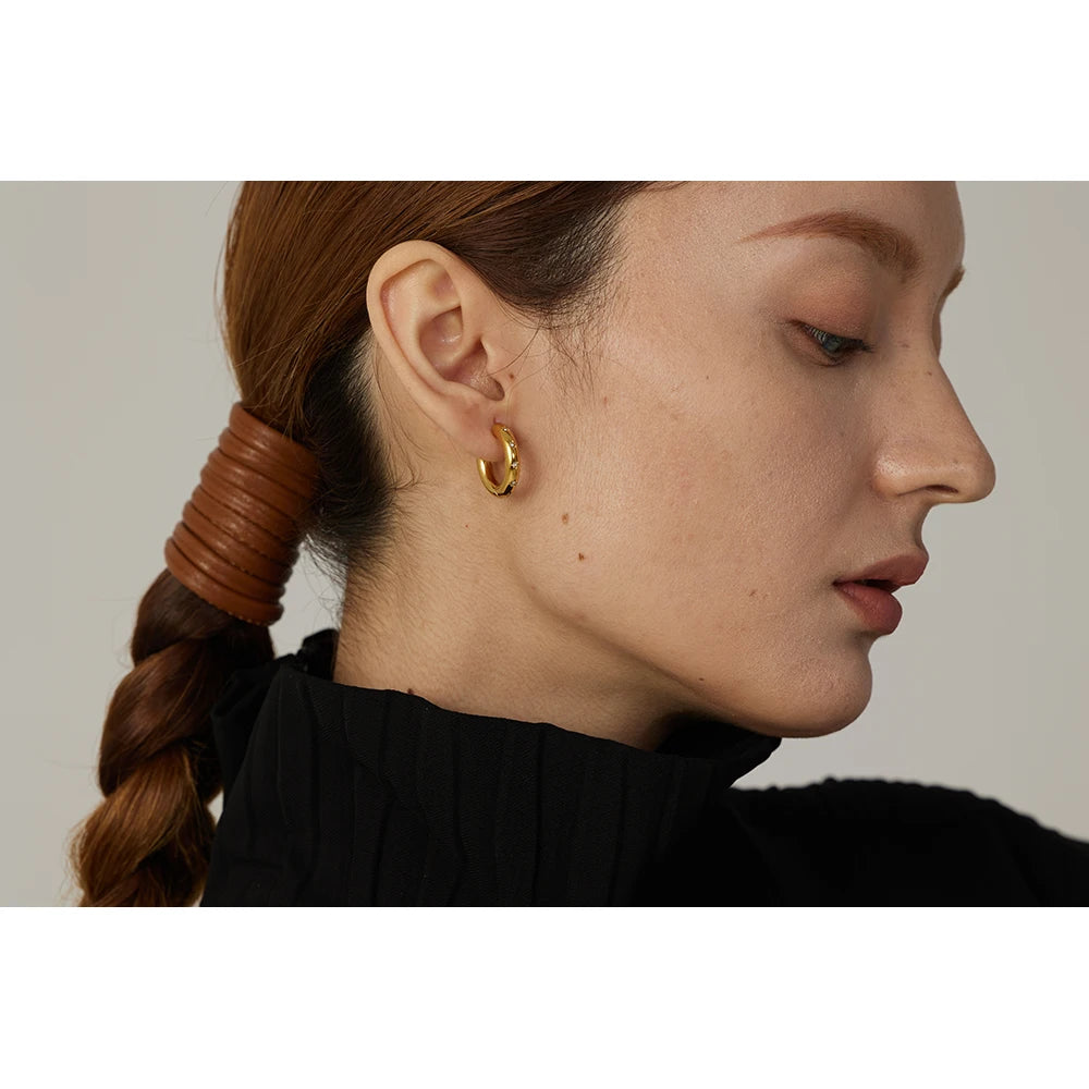 Golden jewelry starburst earrings shaped as sleek huggie hoop earrings