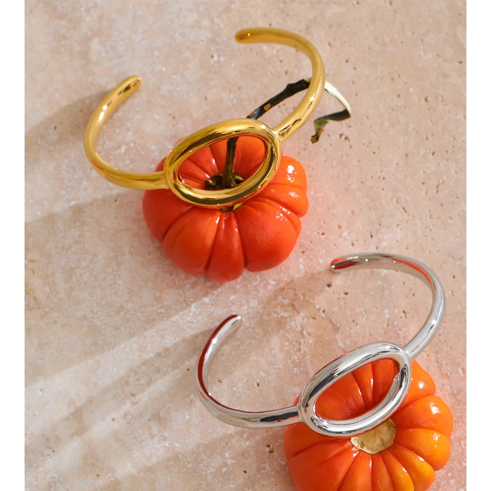 gold bangle bracelet featuring oval hollow design and waterproof finishing