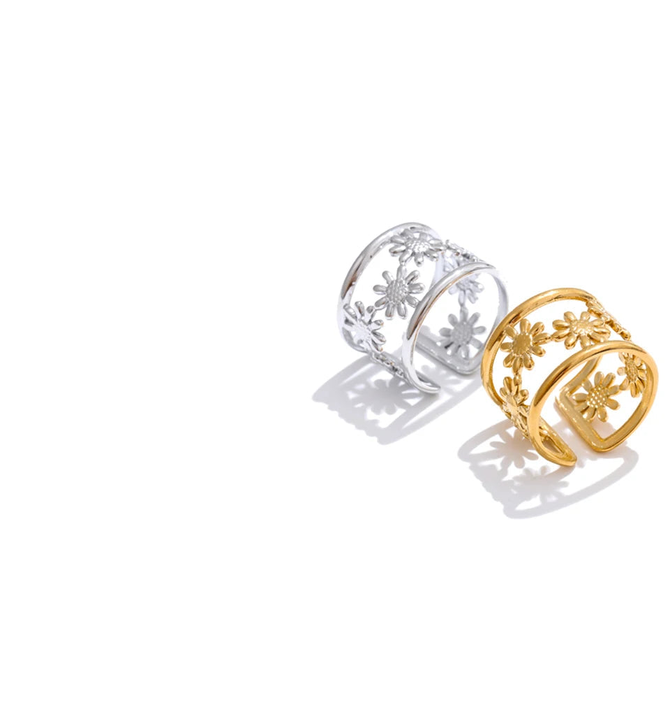 Side angle of adjustable dual-tone ring highlighting interior curve and hollow flower silhouette