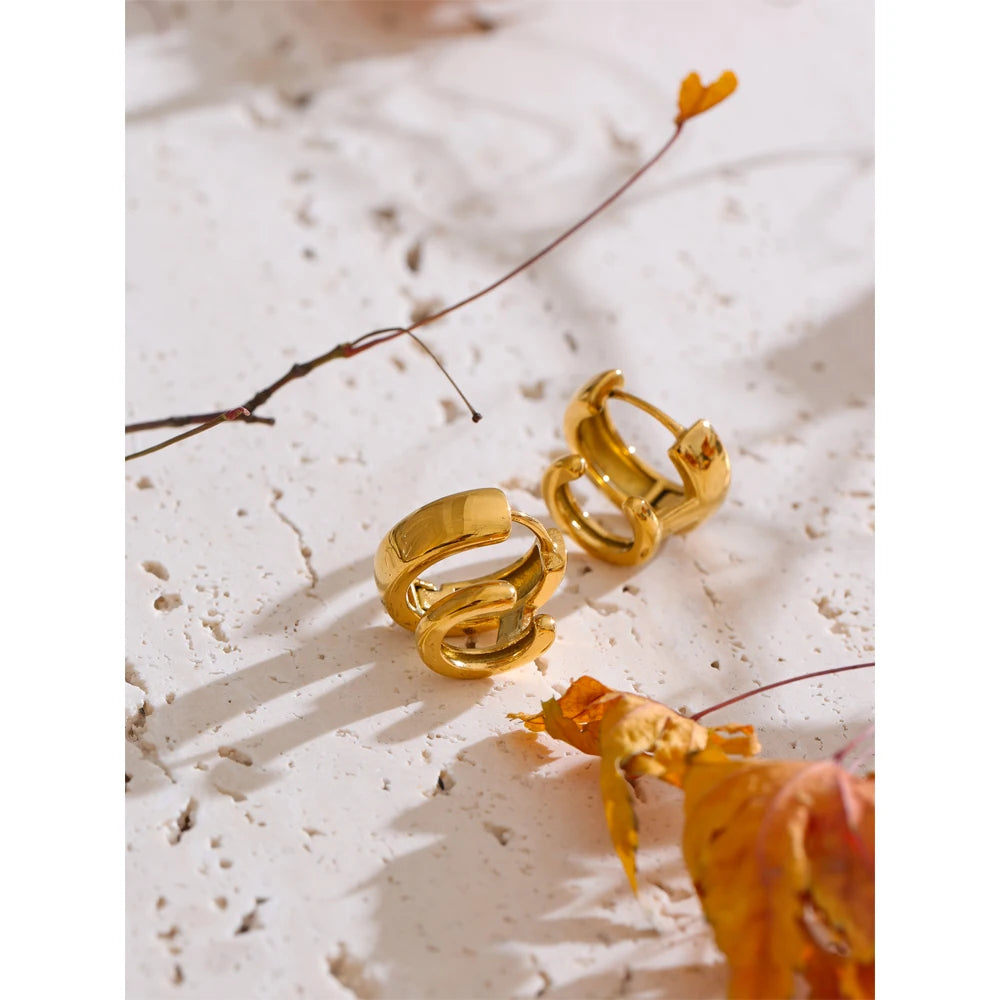 Close view of hoop earrings showing smooth edges and gold plated finish