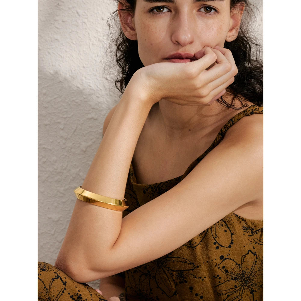 Close view of bracelet charm bracelet showing gold jewelry polish