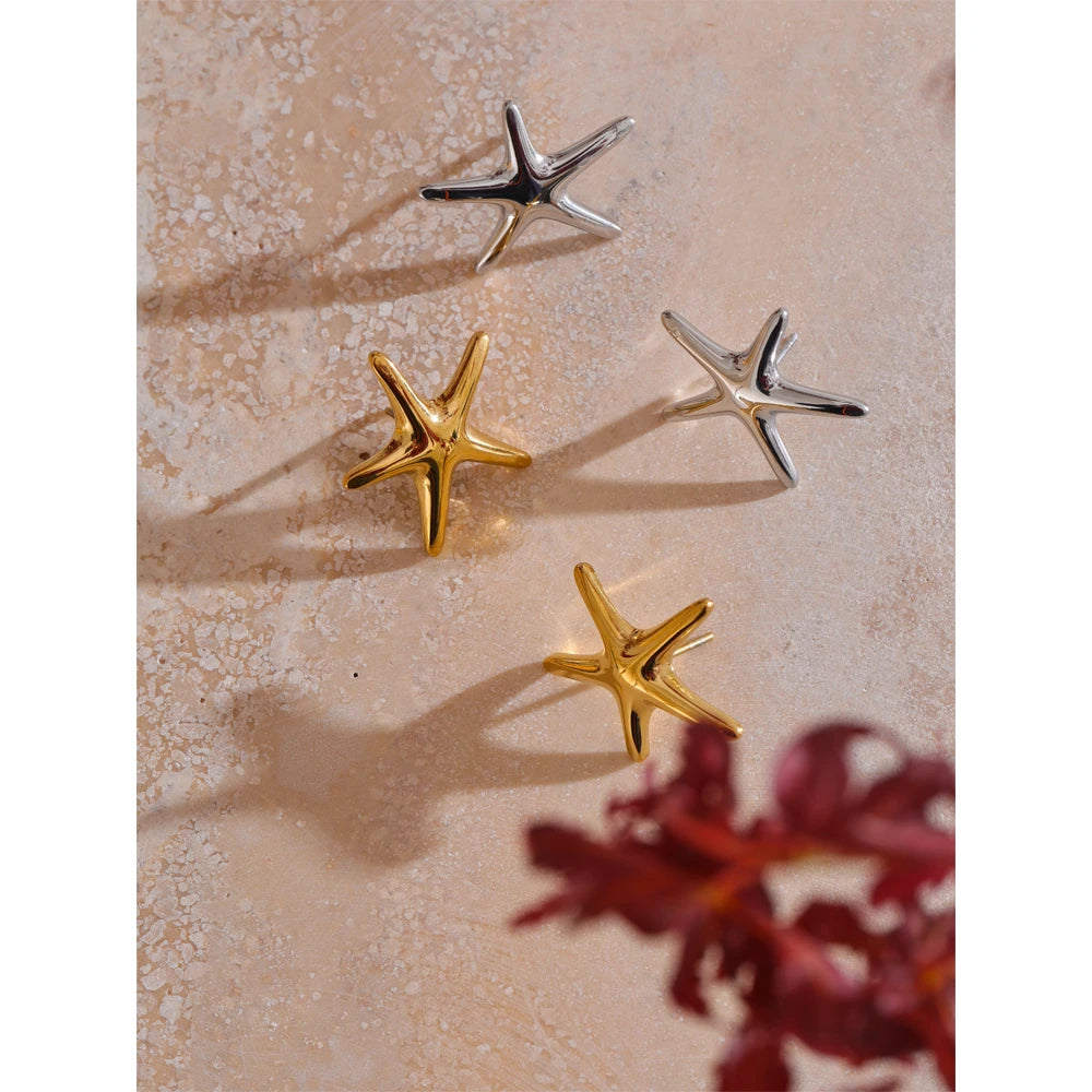 Minimal shot of earrings and gold stack featuring starfish studs gold plated