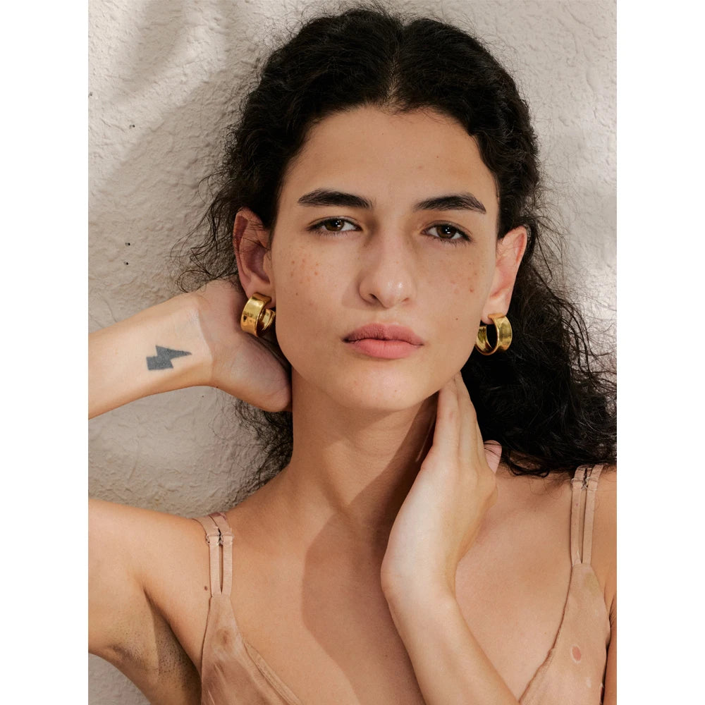 Close up of minimalist earrings hoop earrings showing smooth handcrafted polish