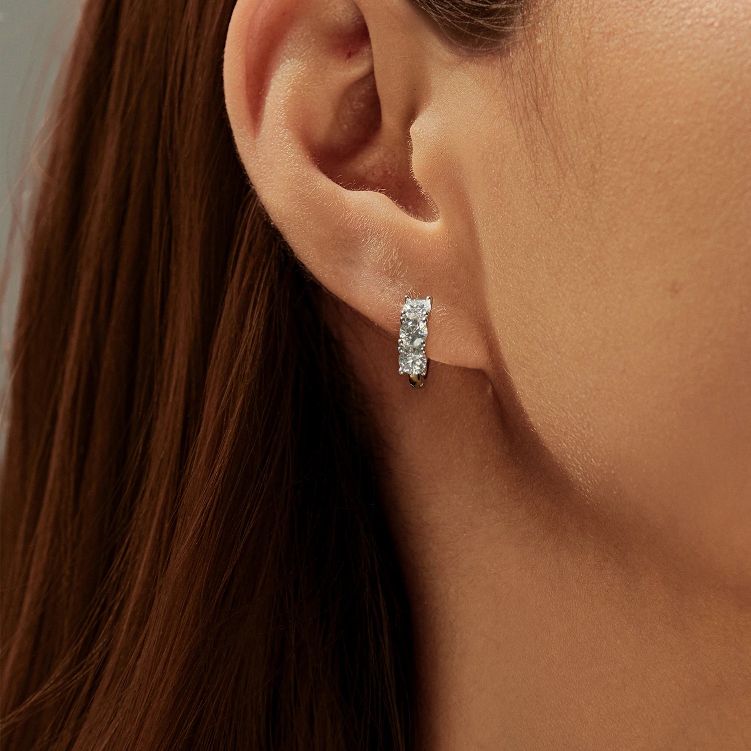 Sterling silver earrings featuring radiant round moissanite stones