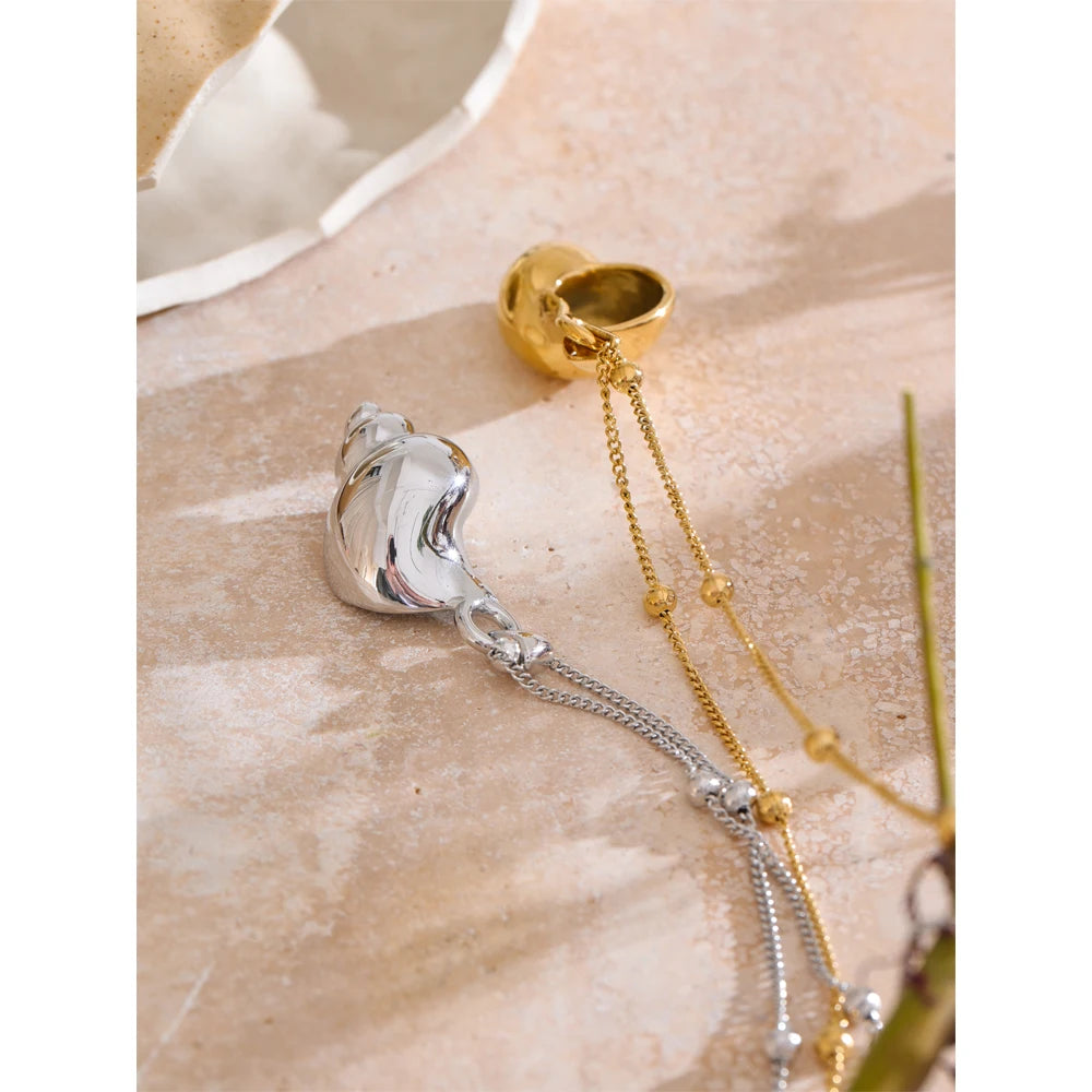 Close view of pendant necklace showing a conch necklace detail gold plated