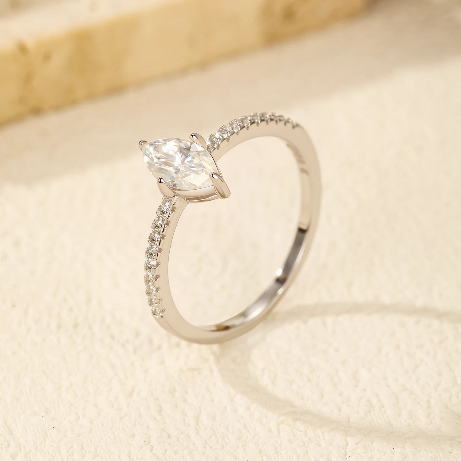 Rings with moissanite styled beside a classic engagement ring