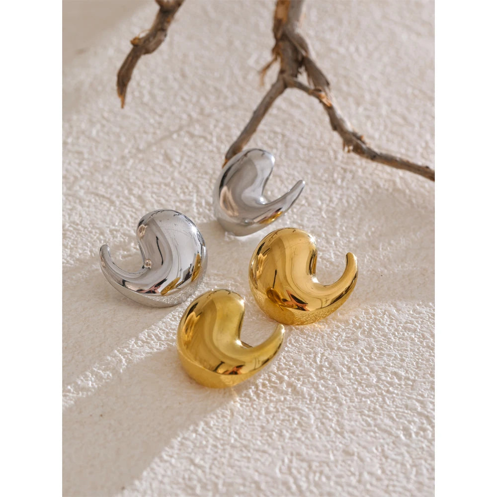 Close-up of comma-shaped stud earrings with gold plated finish