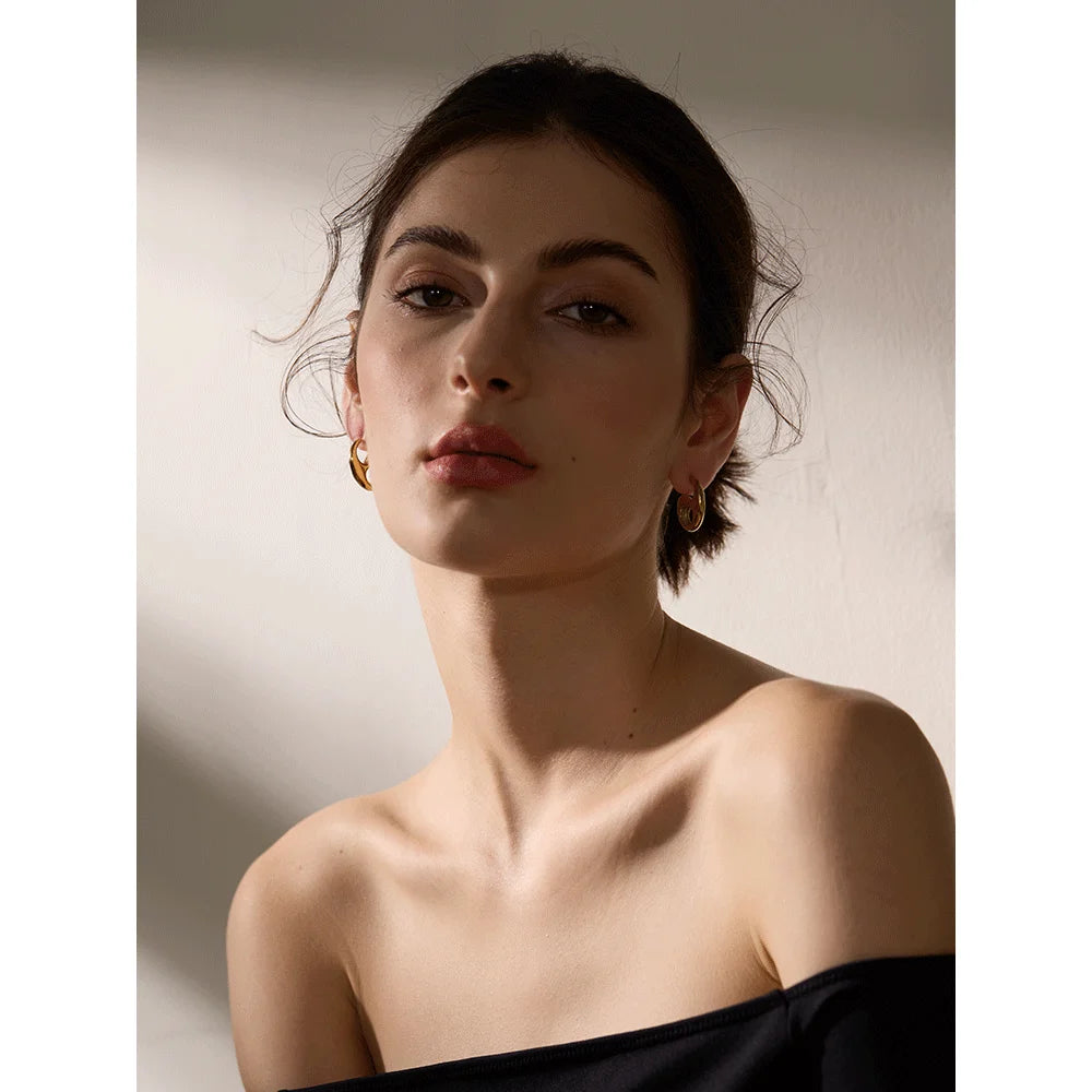 Close view of stainless steel earrings styled as ear rings