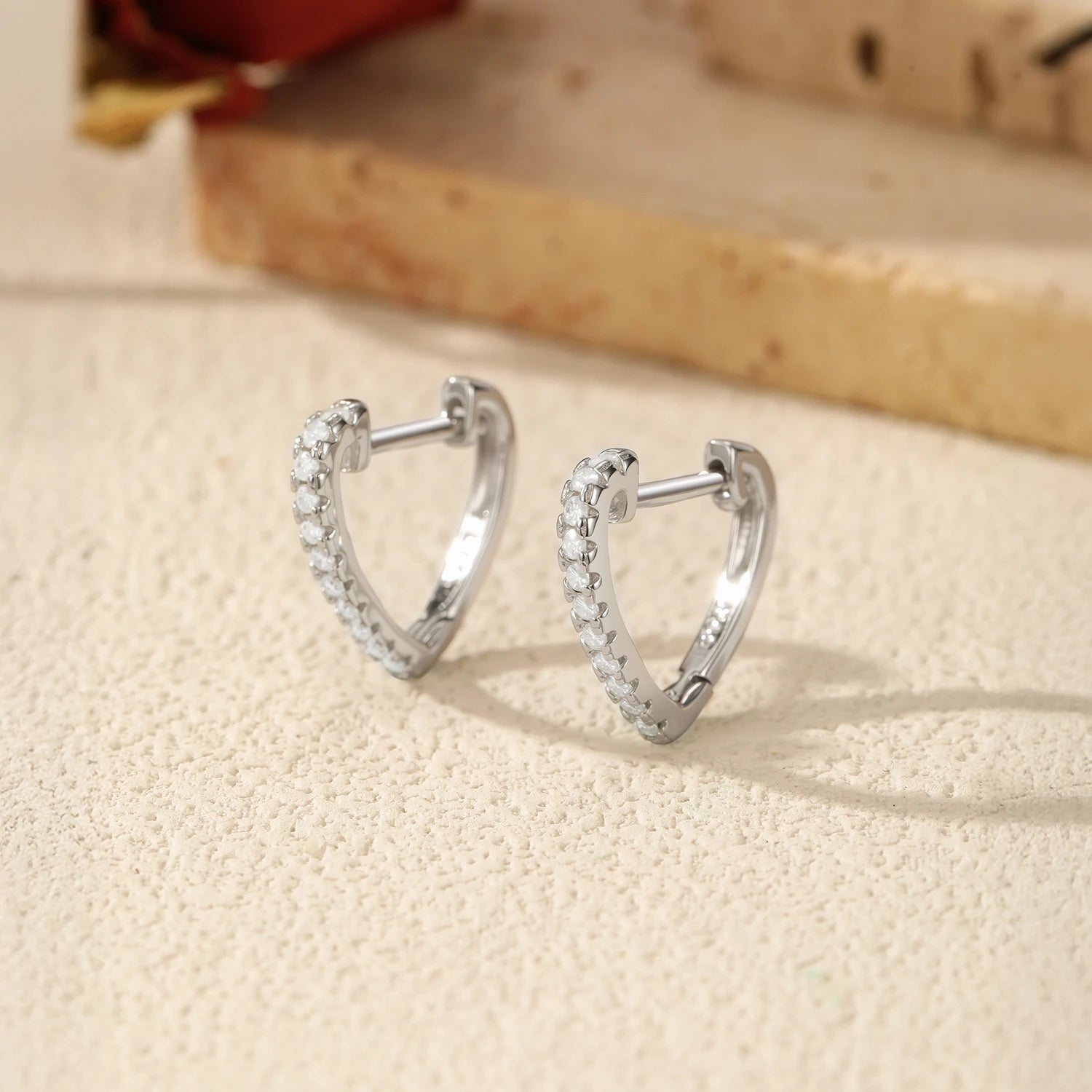 Elegant heart earrings crafted in polished silver with moissanite