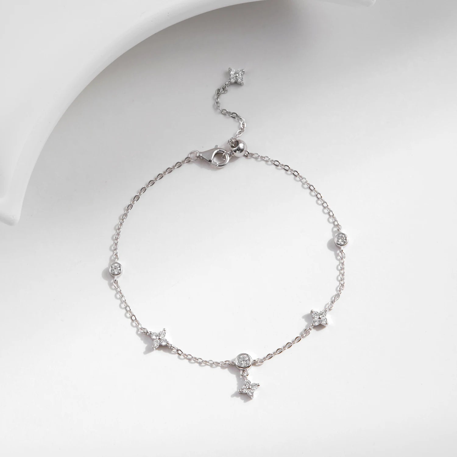 Delicate charm bracelet featuring a lucky clover and bright cz accents